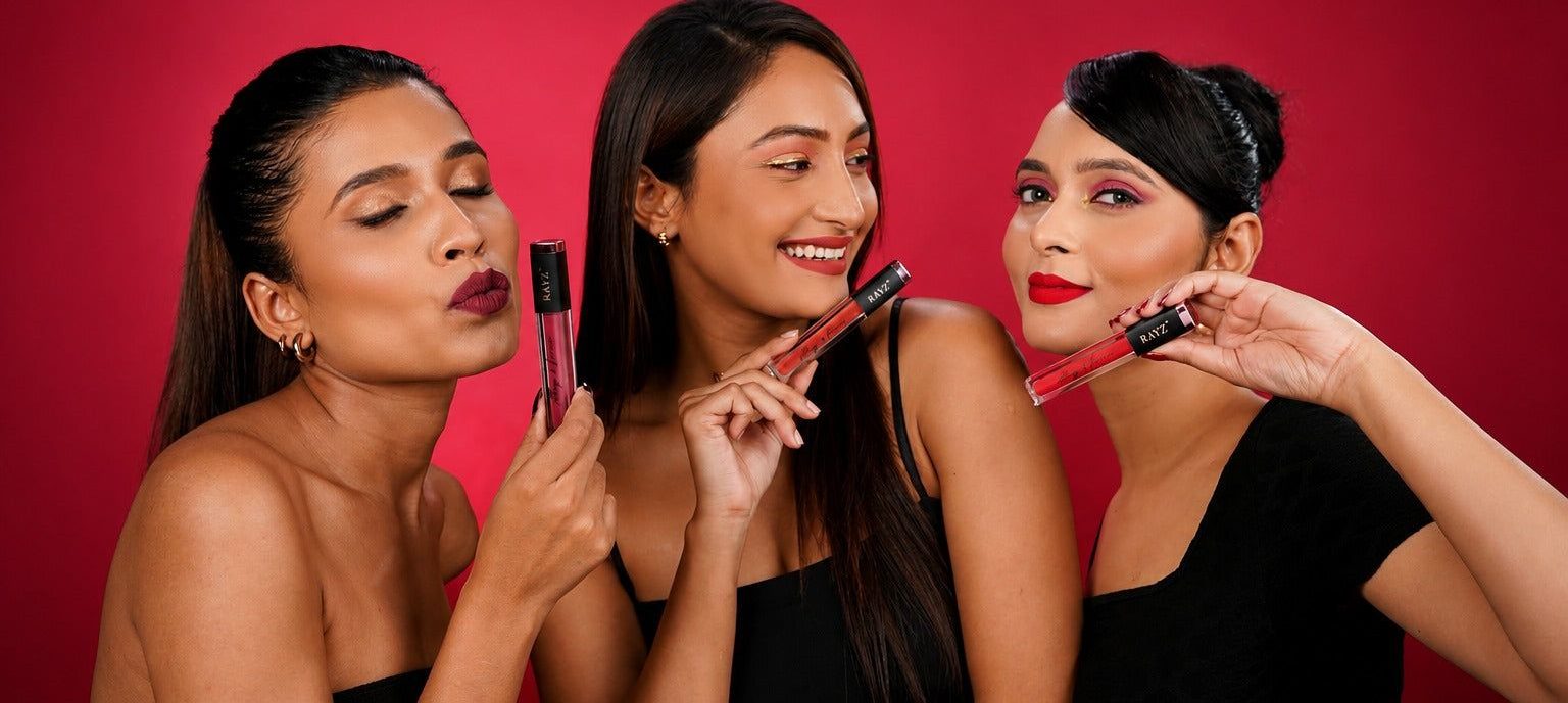 Three women with lipsticks on a red set