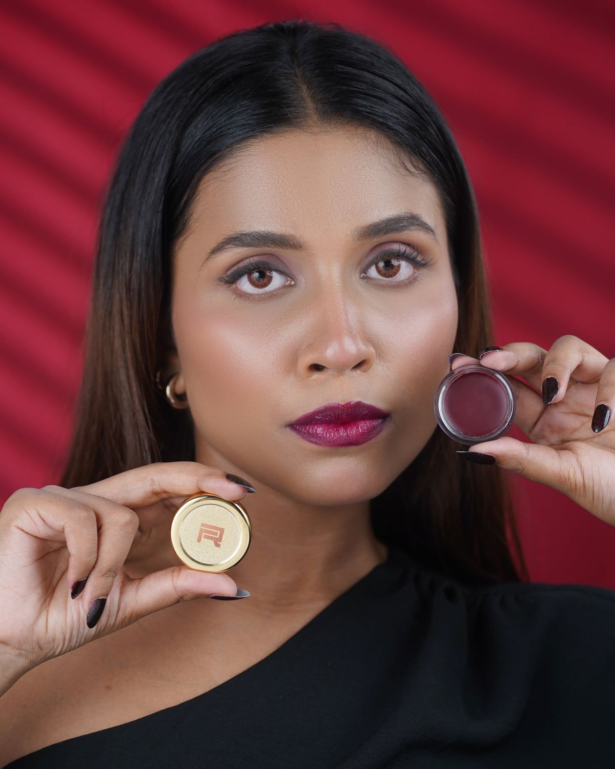 Woman holding a gold tint pot, berry lip